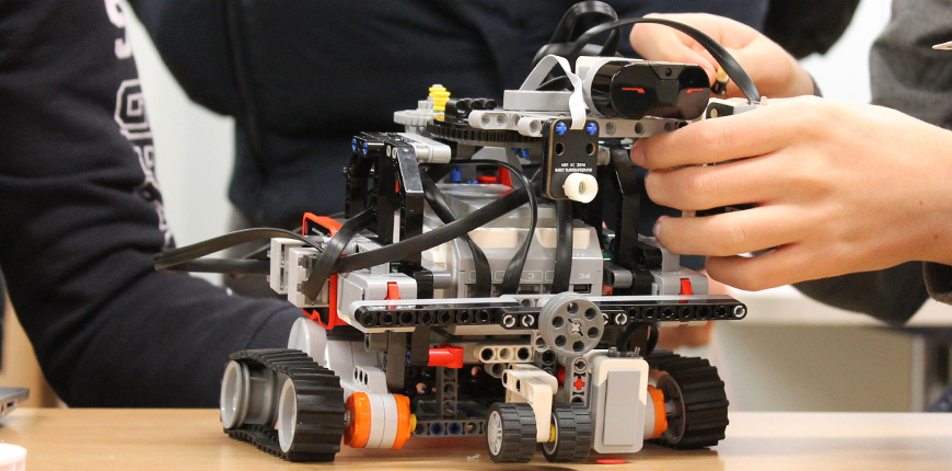 Händer som bygger robot i lego